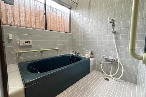a bathroom with a blue tub and a shower at ccb hotel 90Minutes from Tokyo in Chichibu