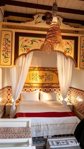a bedroom with a large bed with a canopy at Dar Baaziz 3 in Sousse