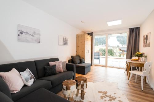 a living room with a couch and a table at APART Forellenhof in Flachau