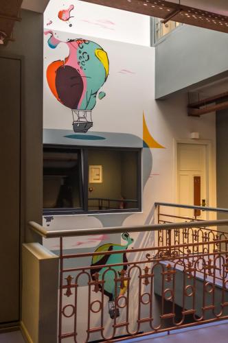 a wall with birds painted on it at Colors Urban Hotel Thessaloniki in Thessaloniki