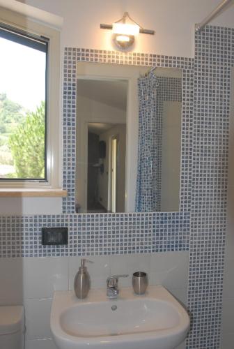 a bathroom with a sink and a mirror at B&B Villa zia Febronia in Patti