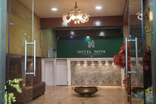 a lobby with a hotel now sign and a bowl at Hotel Nova in Itahari