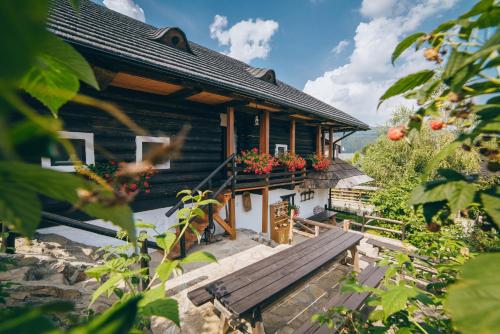 a house with a porch with flowers on it at Pension La Roata in Gura Humorului