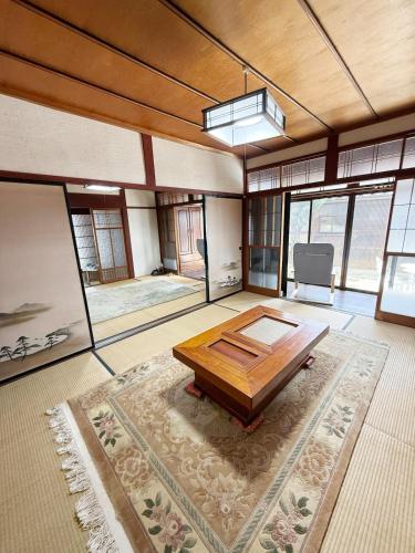 a large room with a wooden table in the middle at fully in Otsu