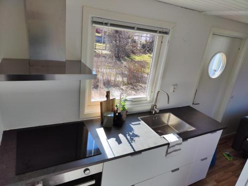 a small kitchen with a sink and a window at Strandskatan 102 in Halmstad