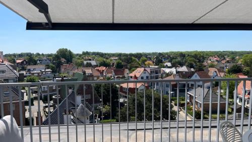 a view of a city from a balcony at Cozy Rooftop - Sint-Idesbald in Koksijde