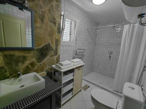 a bathroom with a sink toilet and a shower at Muo Suntime apartment in Muo