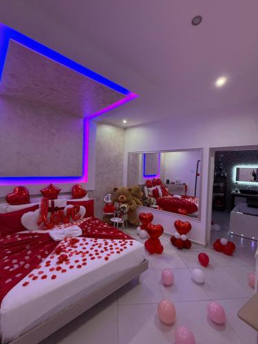 a room with two beds and a large screen at Il Deseo Suite con vasca idromassaggio in Monteparano