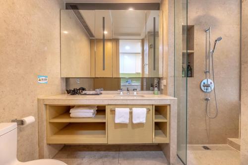 a bathroom with a sink and a shower at HeeFun Apartment GZ -Poly World Trading Center in Guangzhou