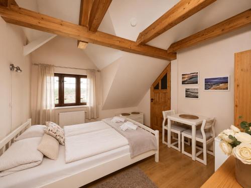 a bedroom with a bed and a table at Pensjonat Natalia Sarbinowo - Blisko Plaży in Sarbinowo