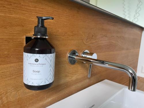 a bottle of soap sitting next to a sink at Weinlandhaus in Mitterretzbach