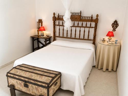 a bedroom with a large bed with a wooden headboard at Casa Denver in El Rompido