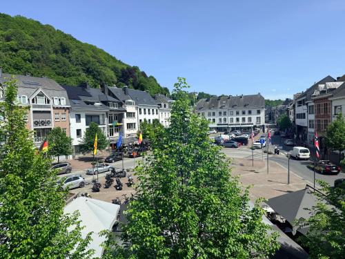 a town with trees in the middle of a street at Hôtel Albert 1er in Malmedy