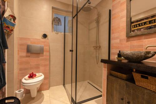 a bathroom with a toilet and a glass shower at Studio Unique in Enschede