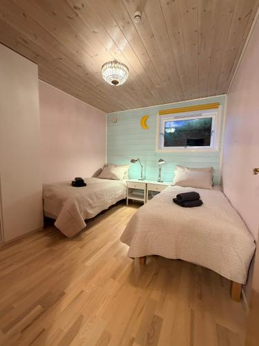 a bedroom with two beds and a window at StarapApartment Odda 3 BR in Odda