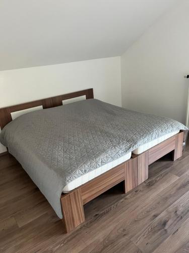 a bed in the corner of a room at Apartma Tri Planike in Mojstrana