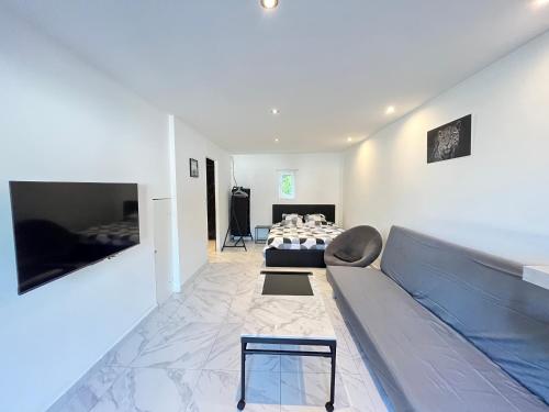 a living room with a couch and a bed at Cosytel in Bègles