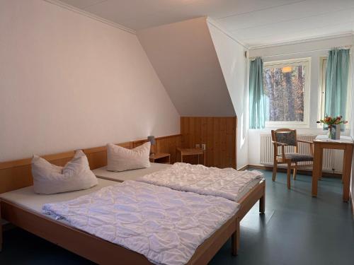 a bedroom with two beds and a window at martas Gästehäuser Groß Väter See in Templin