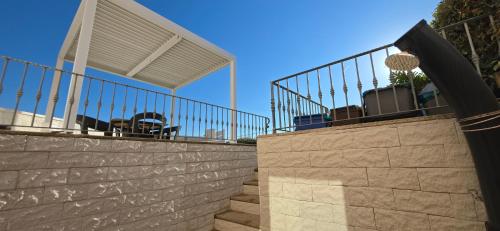 a staircase leading up to a house with a fence at La casa al mare, Pittulongu in Olbia