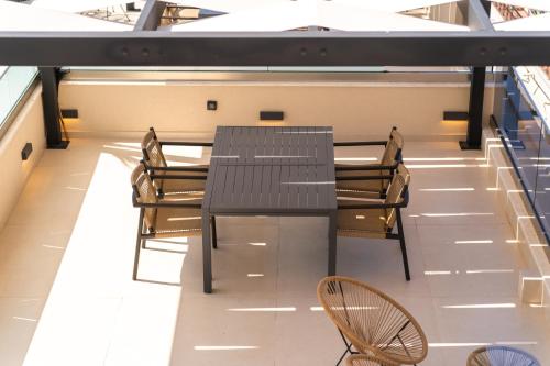 a dining room with a table and chairs at SithoniaRS Boho Edition Luxury Roofgarden II in Neos Marmaras