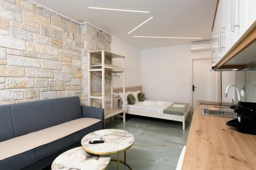 a living room with a couch and a table at VillAge 1912 Studios in Panagia