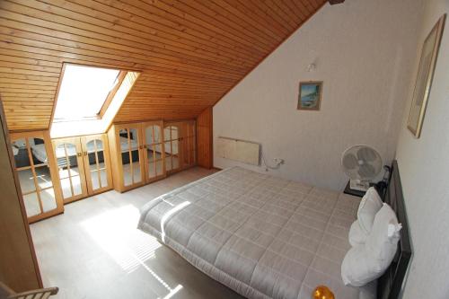 a bedroom with a bed and a large window at Apartments Vrutki in Opatija
