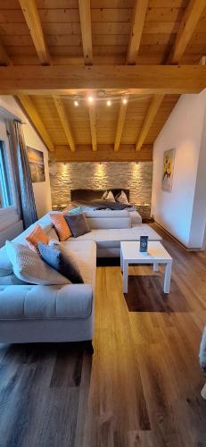 a living room with two couches and a table at Haus Samurai in Saas-Grund