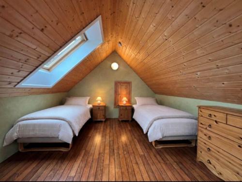 a attic bedroom with two beds and a skylight at 6 person holiday home in Leikanger in Leikanger