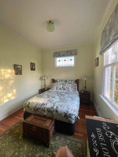 a bedroom with a bed and a sign in it at Rose Lodge Bed & Breakfast in Tirau