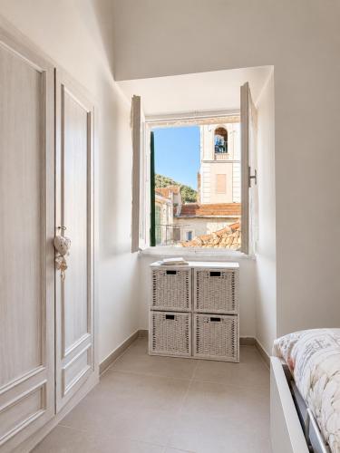 a bedroom with a bed and a window at Ca' Du Marchin, Noli. in Noli