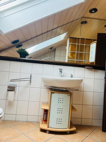 a bathroom with a sink and a mirror at Ruhige Wohnung in Meschede in Meschede