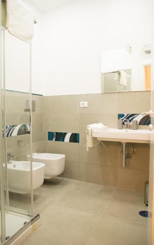 a bathroom with a sink and a tub and a toilet at B&B Il Balconcino a Santa Chiara in Naples