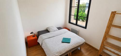 a small bedroom with a bed and a window at Near Train Station in Rennes