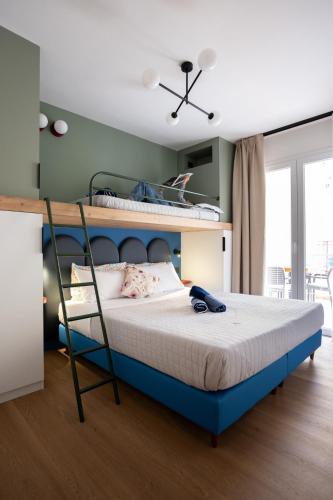 a bedroom with a bed with a blue frame at Casa Merano Residence & Restaurant Bibione Centro in Bibione