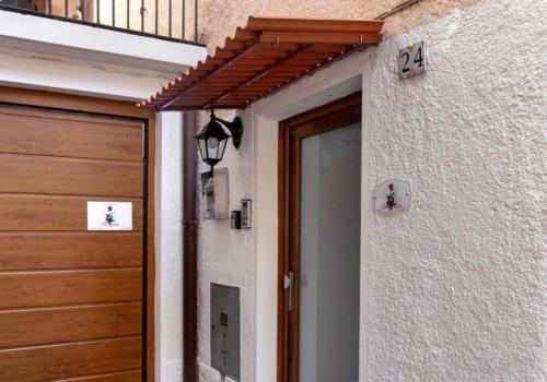 a front door of a house with a wooden door at Cà Rosina Casavacanze in Brusimpiano