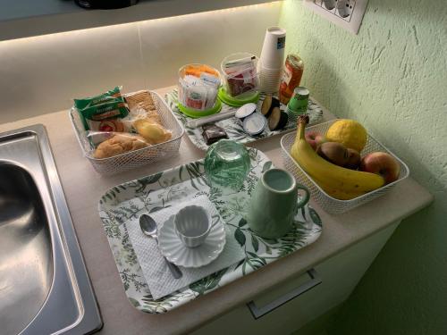 a kitchen counter with a sink and fruits and vegetables at B&B Verde Pastello in Pianopoli