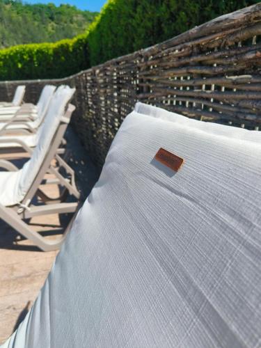a mattress with a book sitting on top of it at Chalets de la Colagne in Chirac
