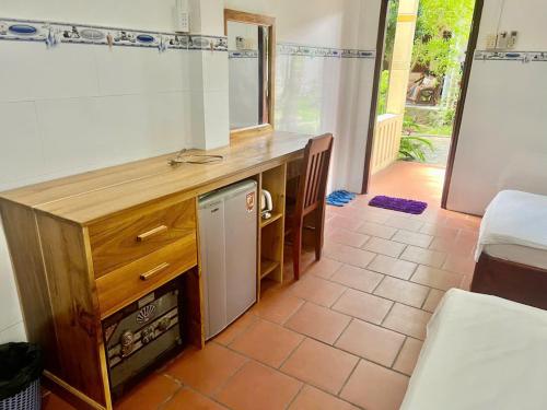 a kitchen with a counter with a dishwasher in it at Bungalow COCO CHILL PQ in Phú Quốc