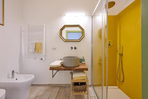 a bathroom with a sink and a toilet and a mirror at OlioeAlloro B&B in San Vincenzo