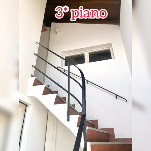 a spiral staircase in a building with a pizza sign at Appartamento Ascona , rooftop terrace apartment in Ascona
