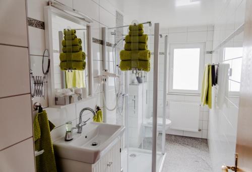 a white bathroom with a sink and a toilet at Ferienwohnung Münch mit Balkon in Großheubach