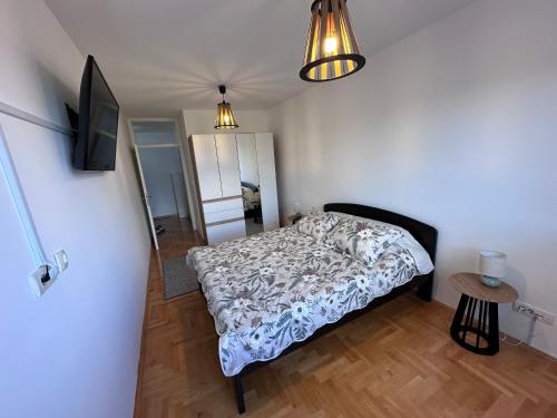 a bedroom with a bed and a flat screen tv at Residence 16 in Belgrade