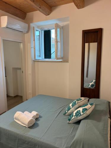 a bedroom with a bed with two towels on it at Almarè in Grottammare