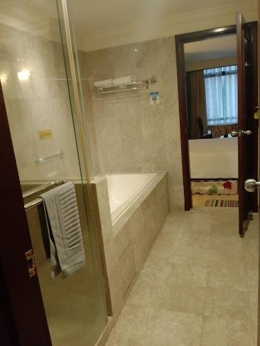 a bathroom with a shower and a bath tub at Elevate suite Hotel time square kl in Kuala Lumpur