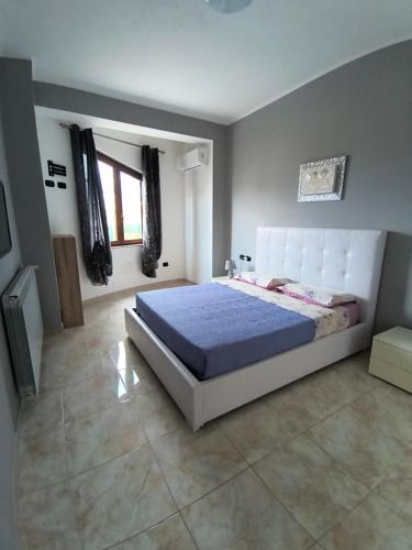 a bedroom with a large bed in a room at Dimora Melania in San Nicola Arcella