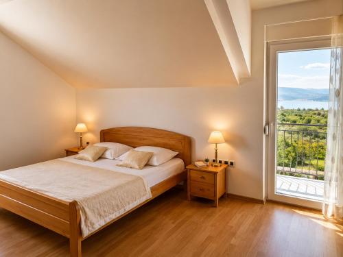 a bedroom with a bed and a large window at Grabovica Sobe-Blue Lake Luxury Rooms in Grabovica