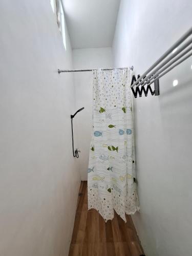 a room with a curtain hanging on a wall at Athara Naya in Karangploso