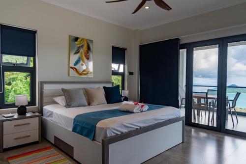 a bedroom with a bed with a view of the ocean at Fairview Heights in Victoria