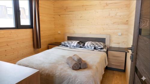 a bedroom with a bed with two towels on it at Tsovazard Lake House in Tsovazard