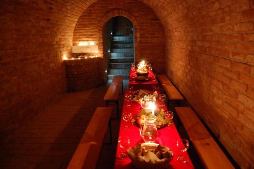a long table in a room with a red table cloth at Penzion Dolní Dunajovice in Dolní Dunajovice